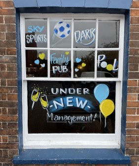 Commercial Inn window art - under new management