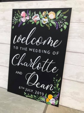 Hand painted flowers and personalised chalkboard wedding welcome sign