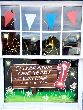 Window painting to celebrate 1 year of new management at the commercial inn